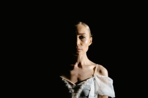 ballerina-clipart-a-woman-in-white-dress-is-standing-the-dark
