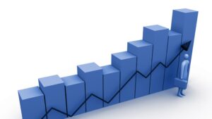 growth-clipart-a-person-standing-next-to-bar-chart